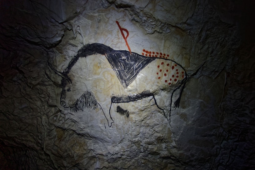 a cave painting of a man riding a horse