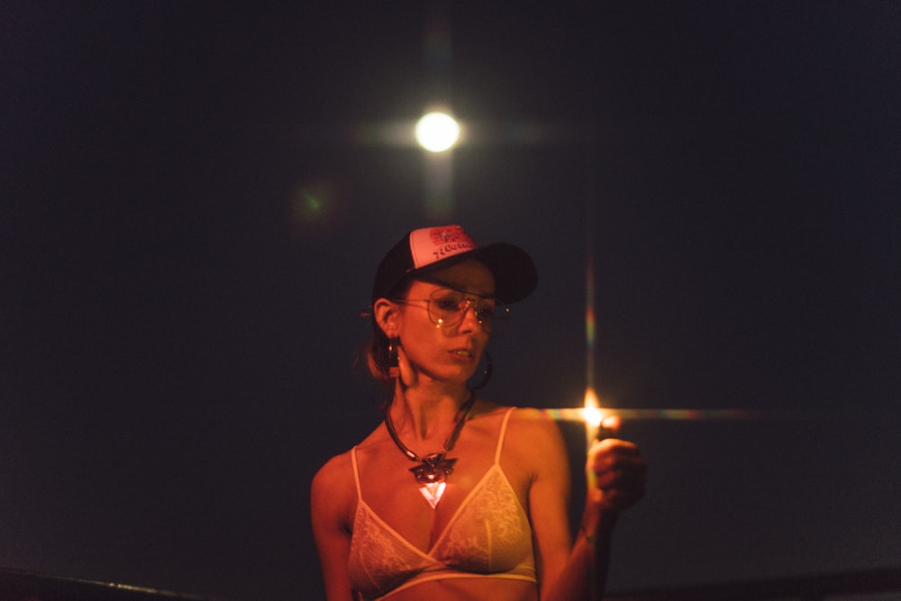 woman wearing white bra and cap