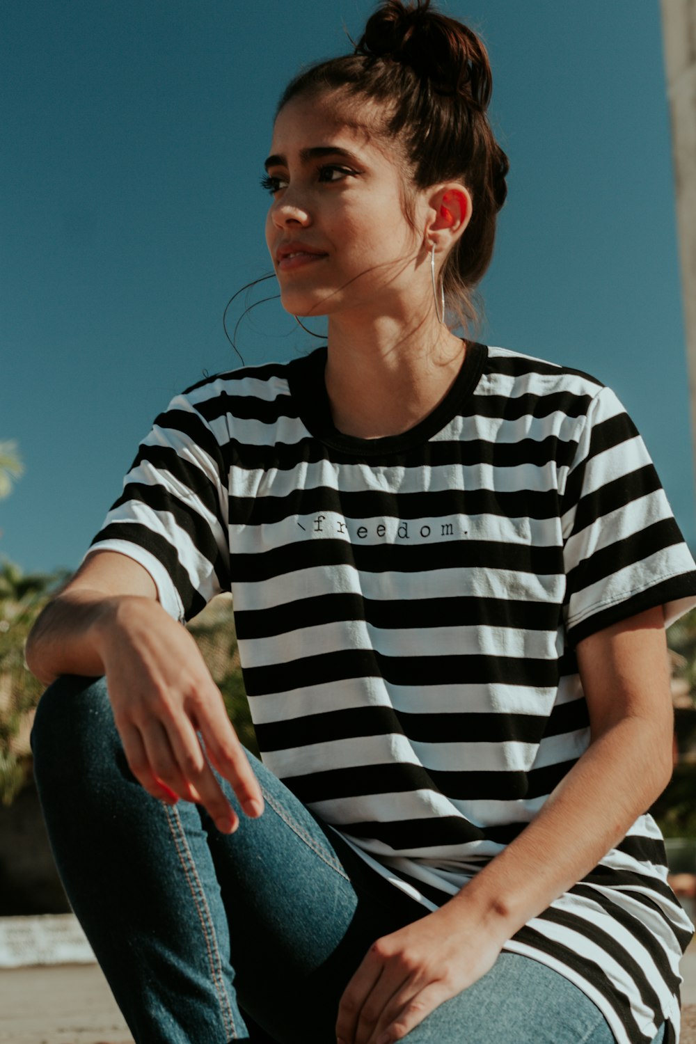 shallow focus photo of woman in white and black striped crew-neck T-shirt