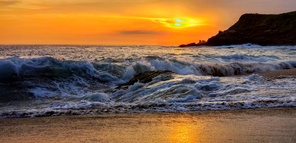 blue beach under orange sky