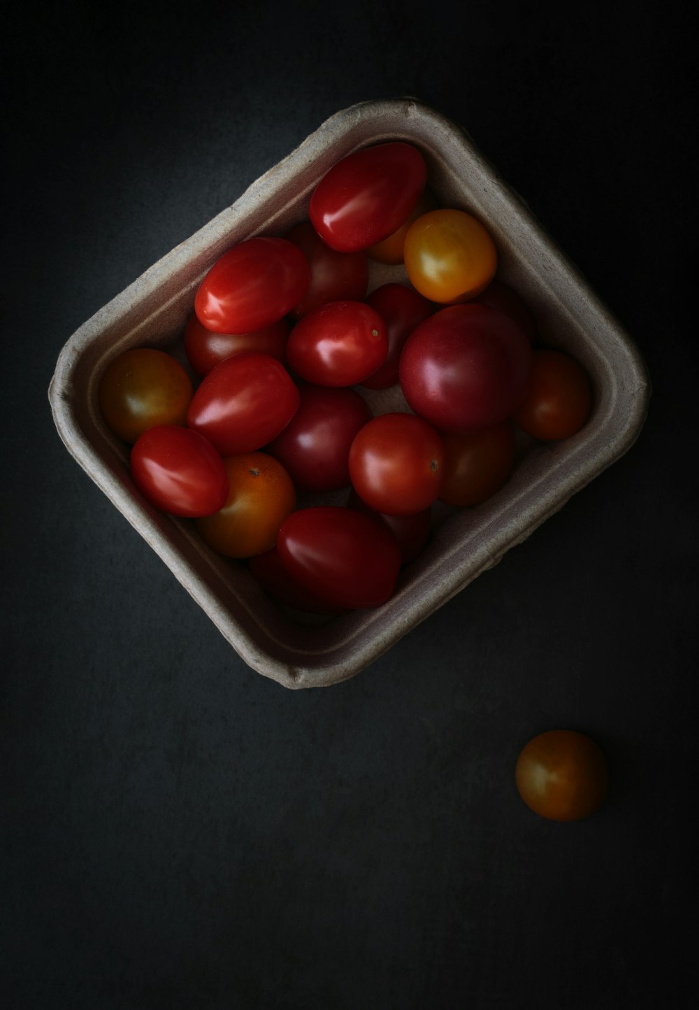 round red fruits on white plastic container