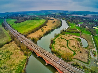 bridge over the river under grey cloudy sky