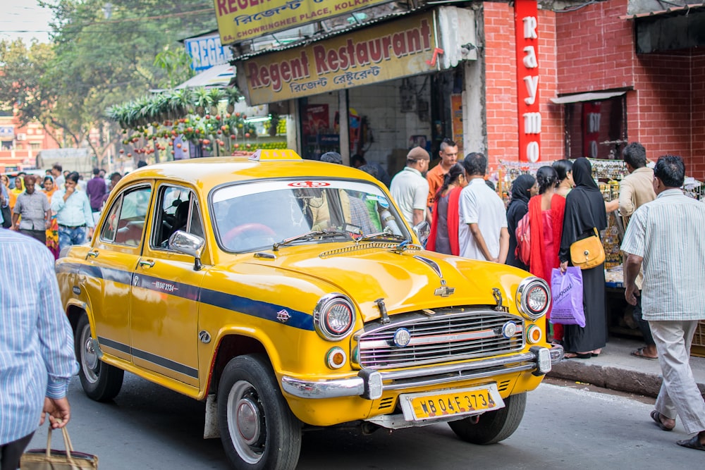 yellow sedan on road