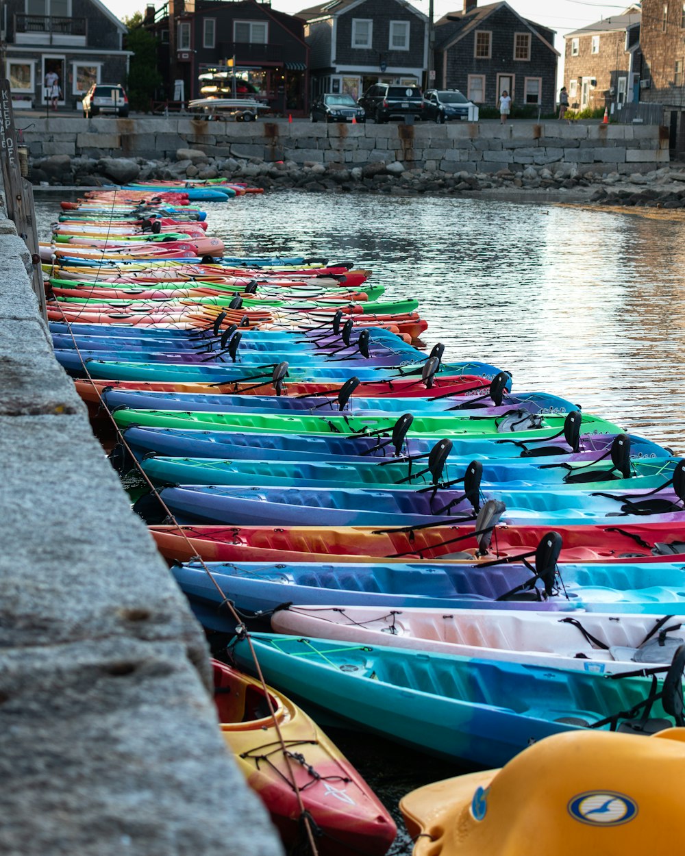 assorted-color plastic kayaks on sea