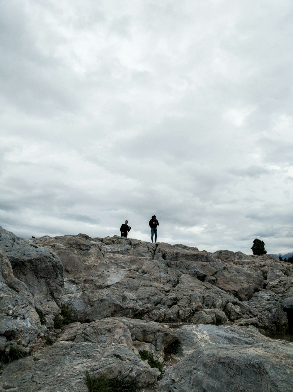 two persons under cloudy sky