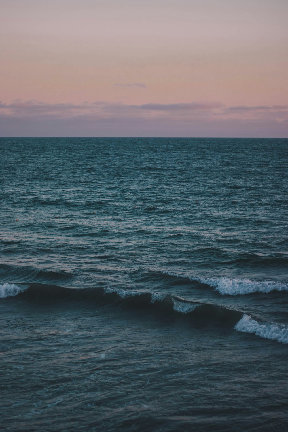 grey and pink sunset sky over the sea