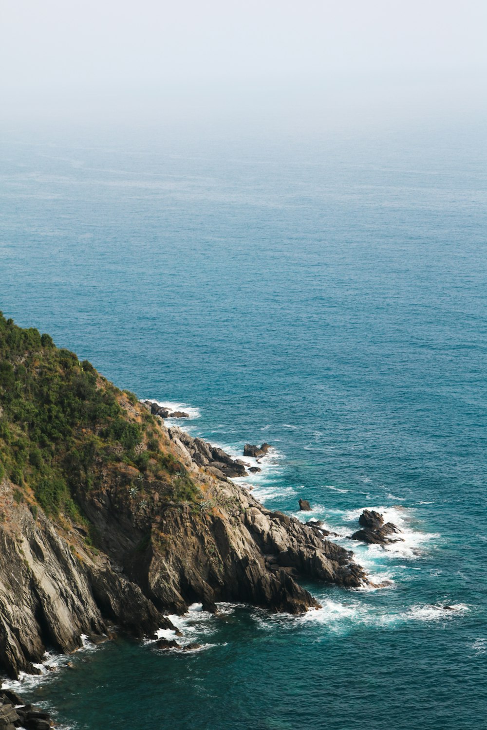 green mountain and body of water