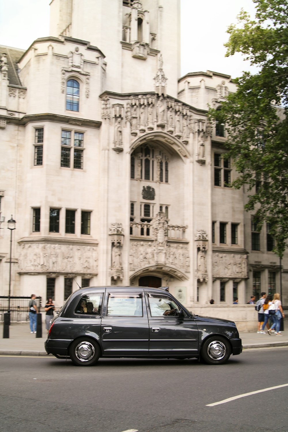 black taxi cab turning at street corner