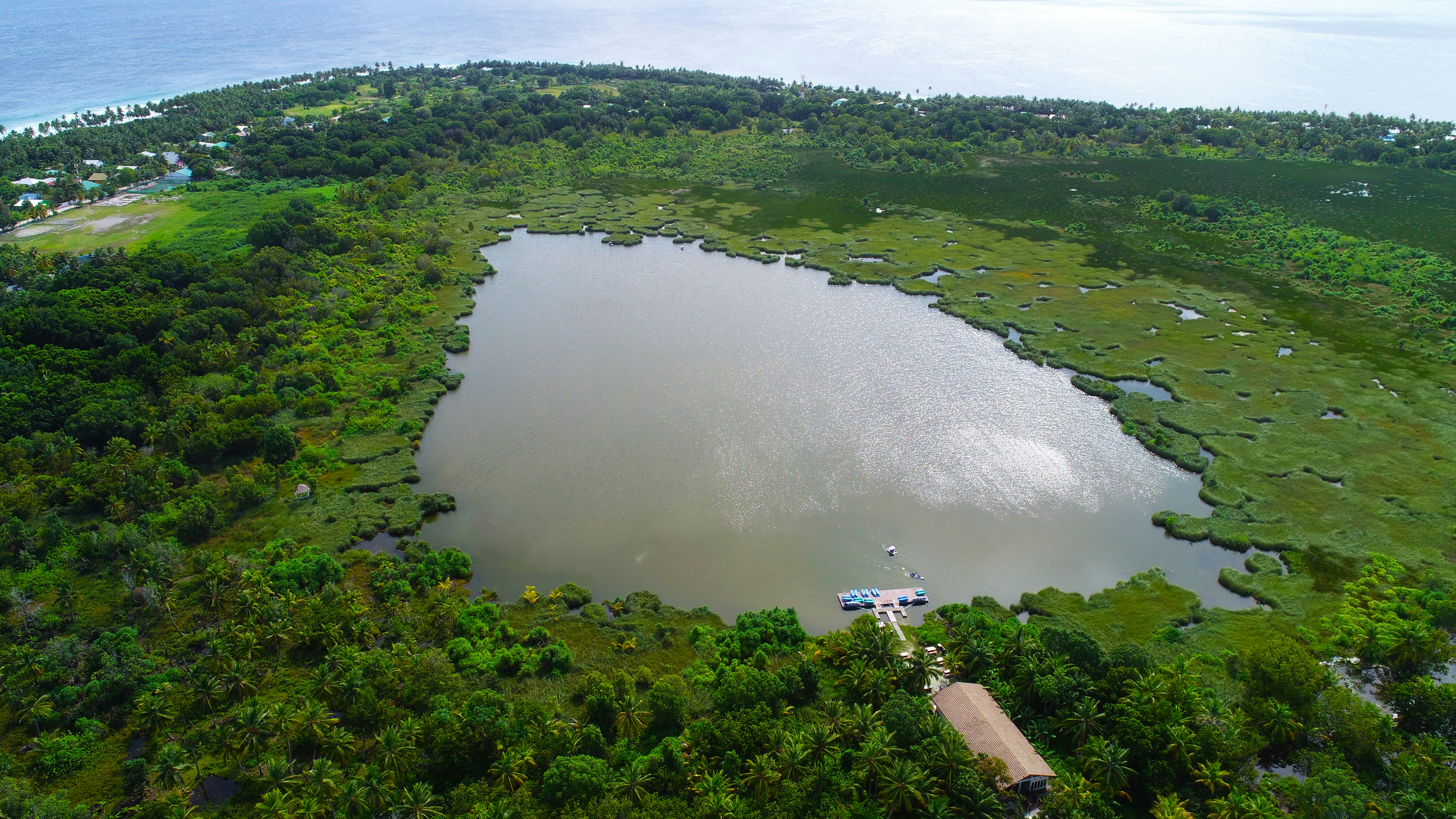 Aerial view of exclusive private island with lush vegetation and private dock