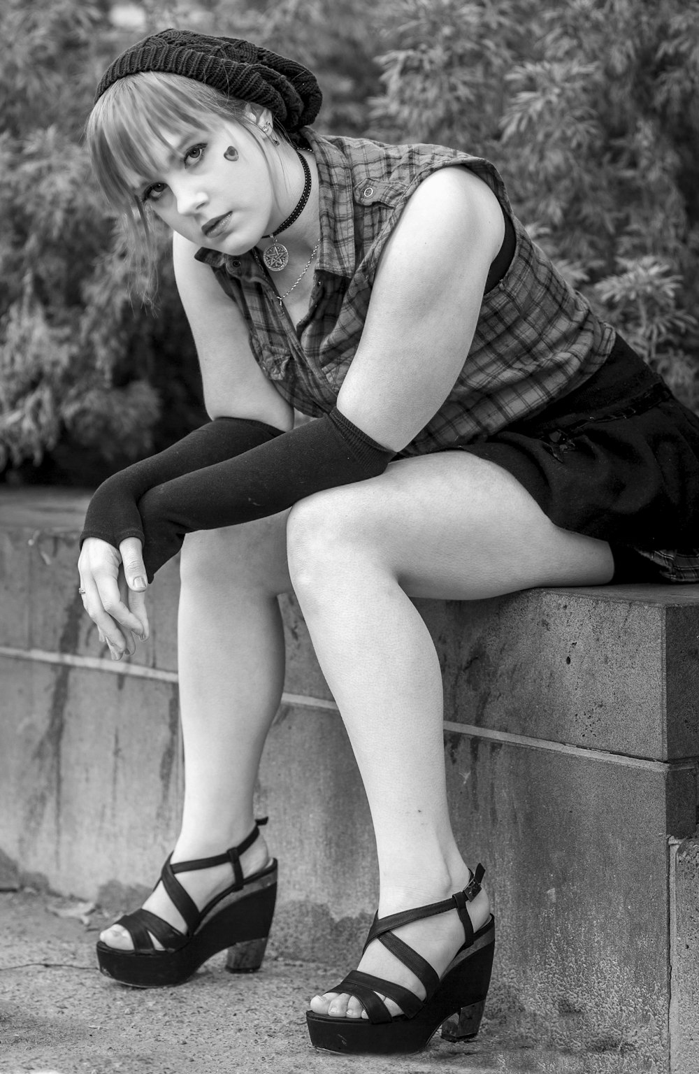 woman sitting on pavement