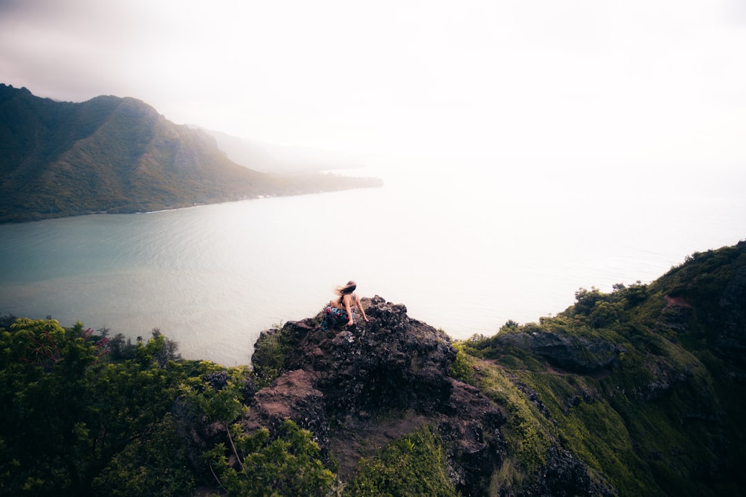 woman sitting on cliff