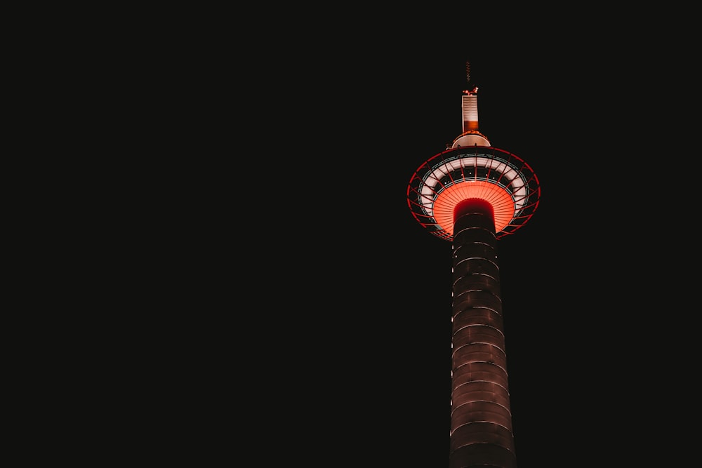 a tall tower with a red light on top of it