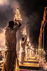 men holding tray of fire