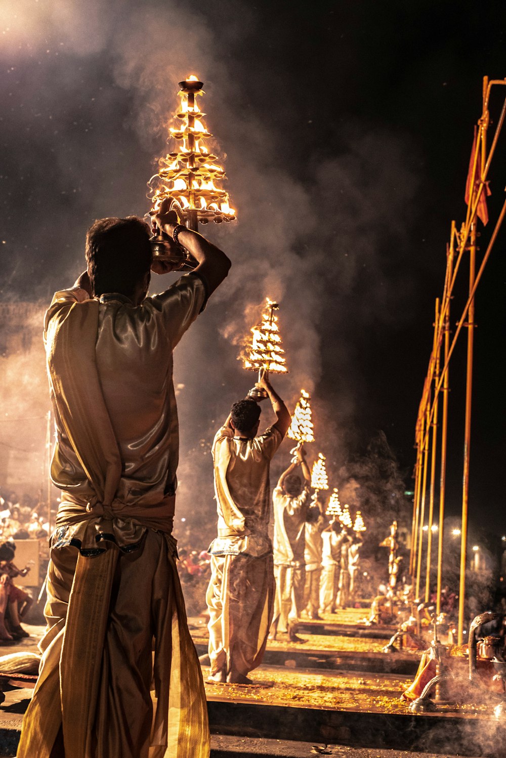 men holding tray of fire