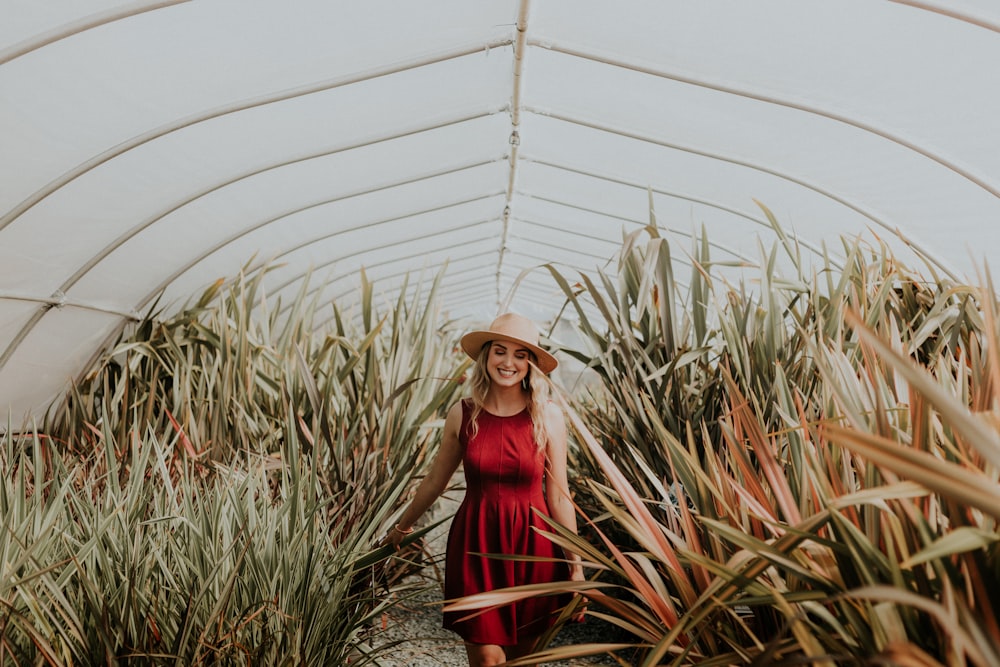 smiling woman inside green house