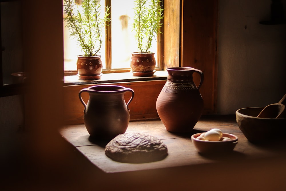 flower pots on table near window