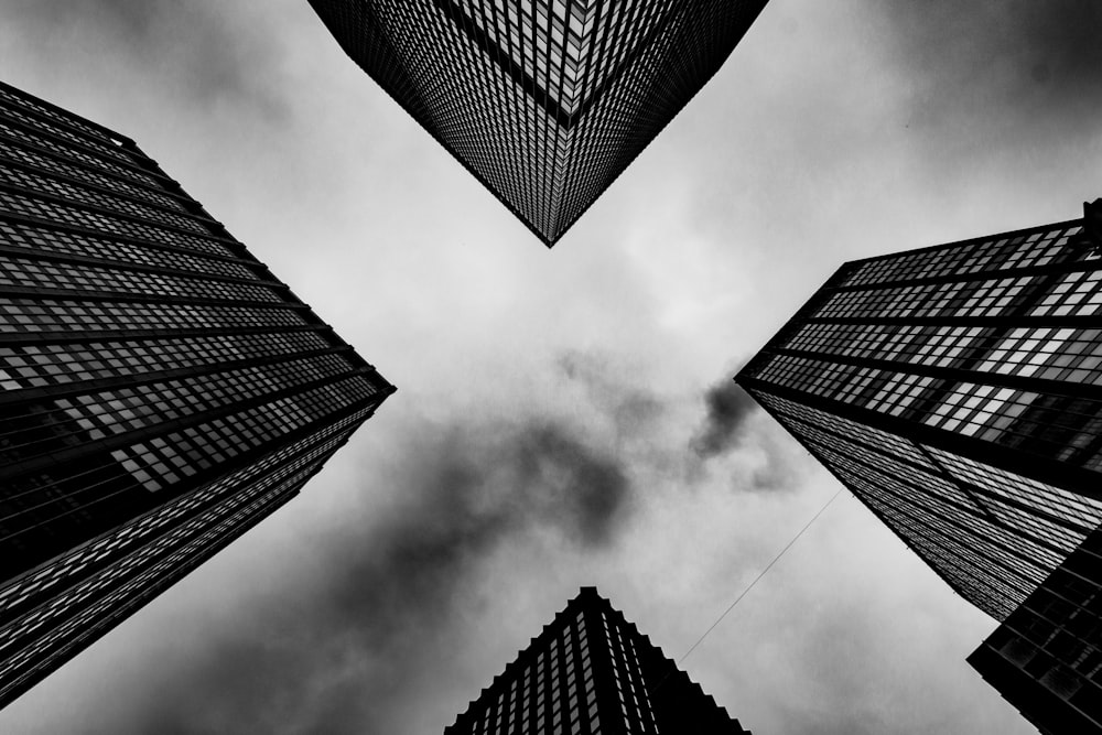 low angle photography of four high rise buildings