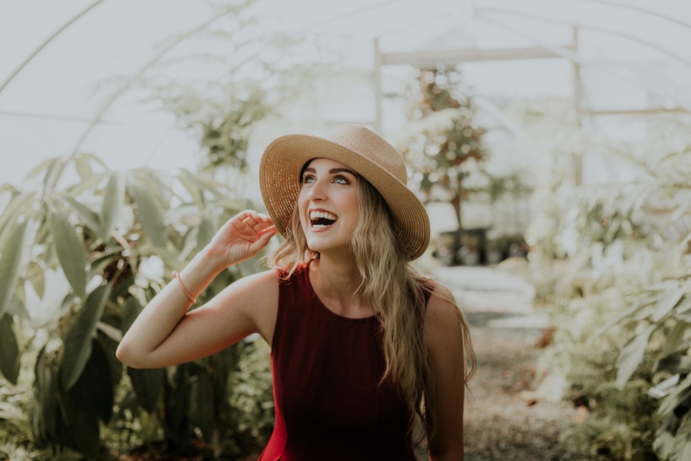 mulher sorridente usando vestido vermelho sem mangas