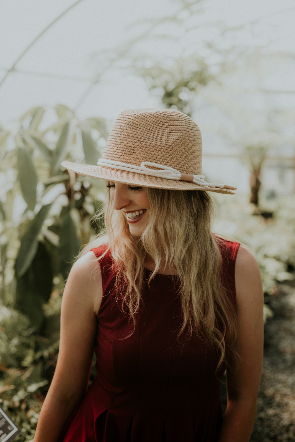 smiling woman wearing red sleeveless dress