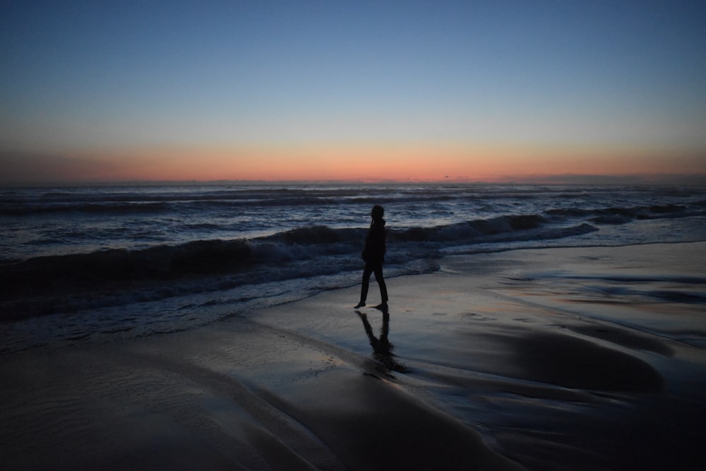 man standing on seashore