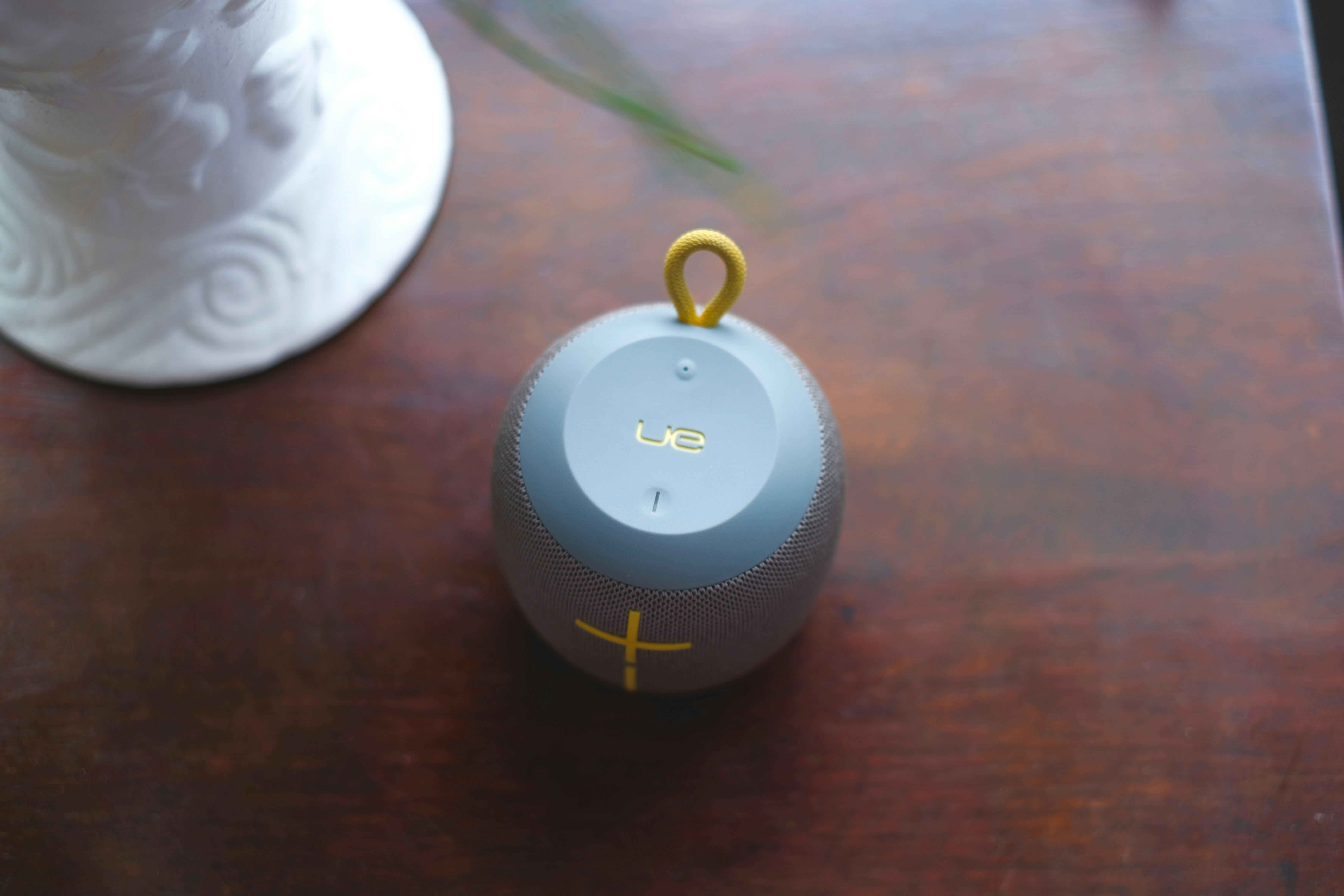 gray UE Boom speaker on table