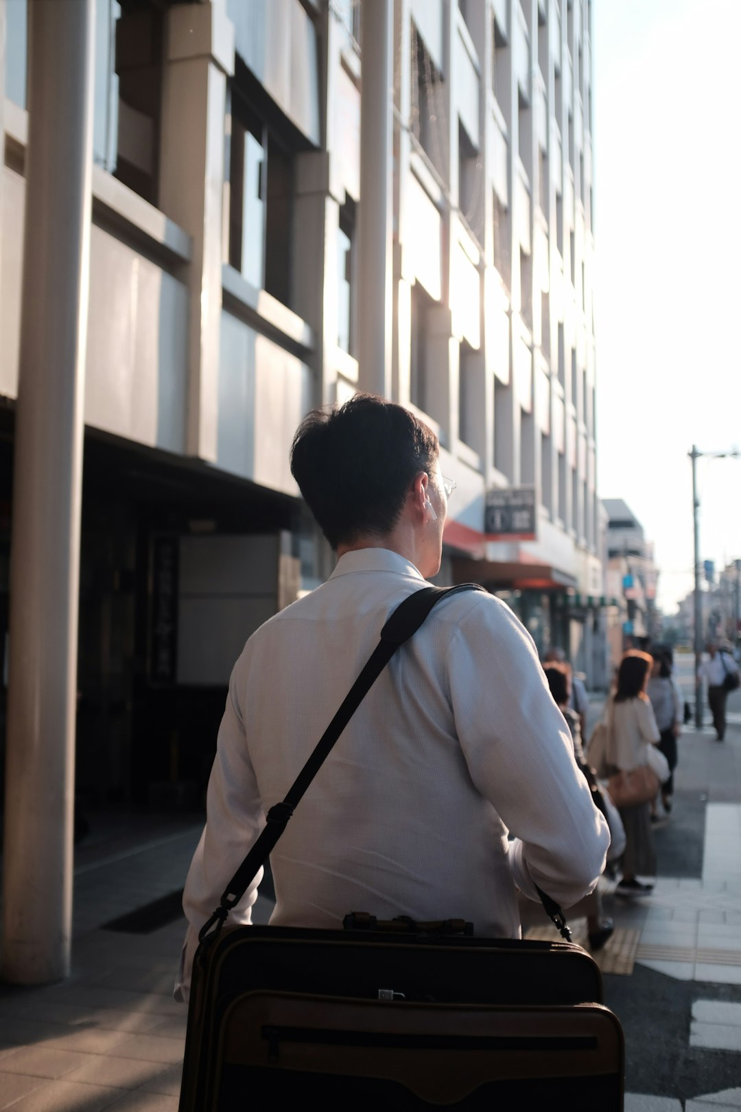 man carrying laptop bag