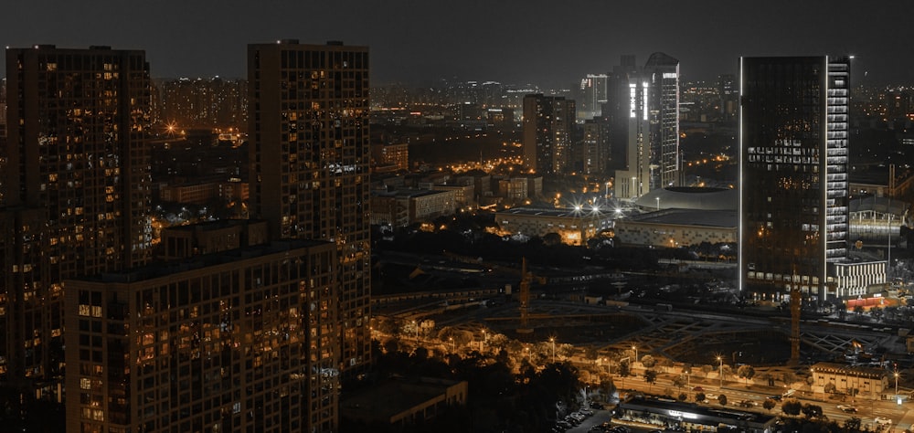 high rise city buildings with lights on during nighttime