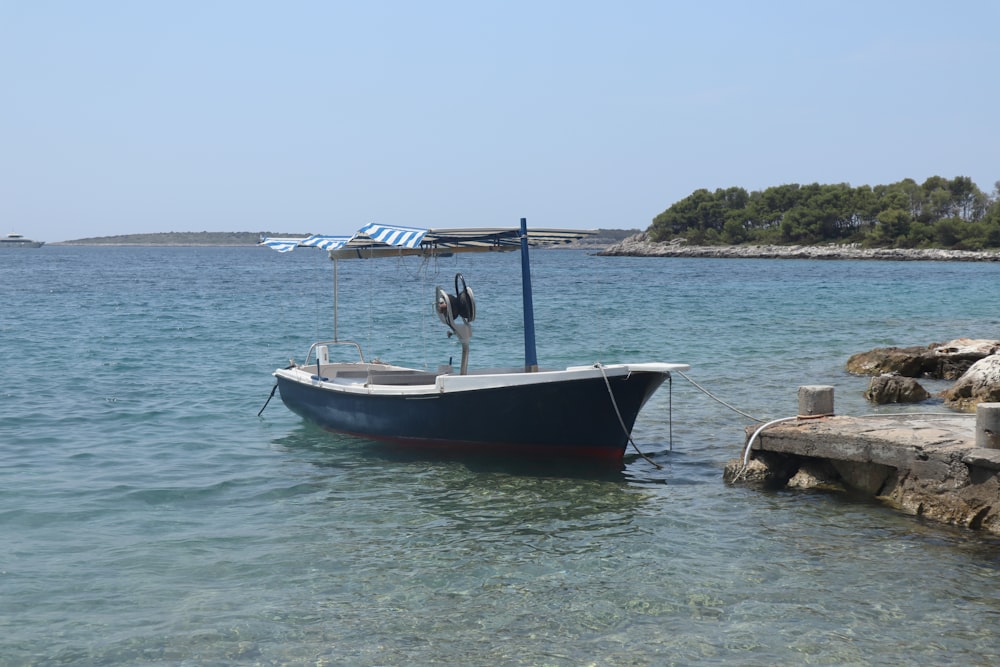 white boat on body of water during daytime