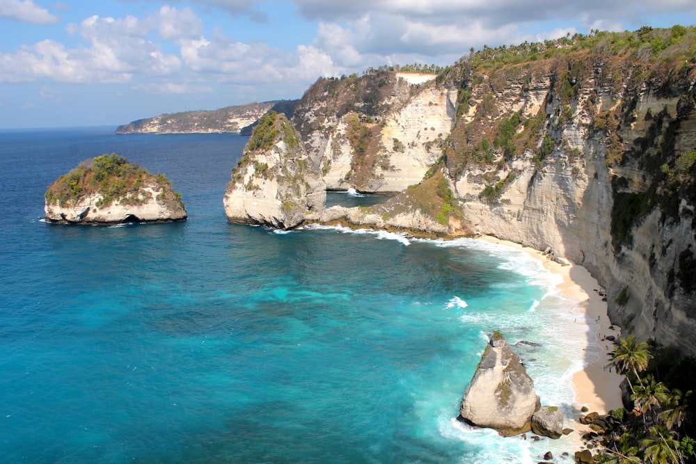 cliff near body of water during daytime