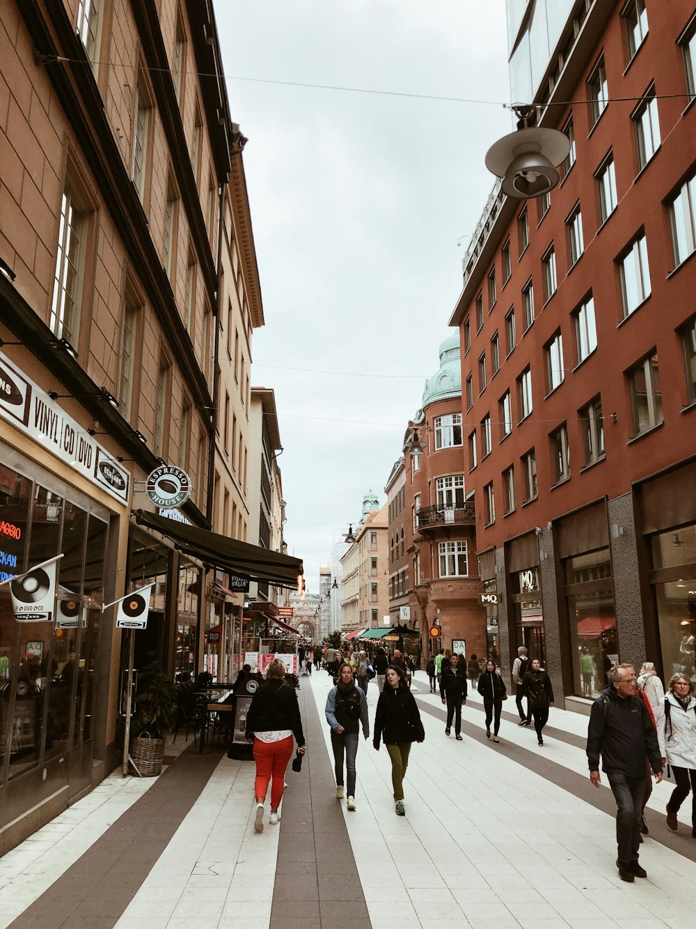 people walking in alley near buildings during daytime