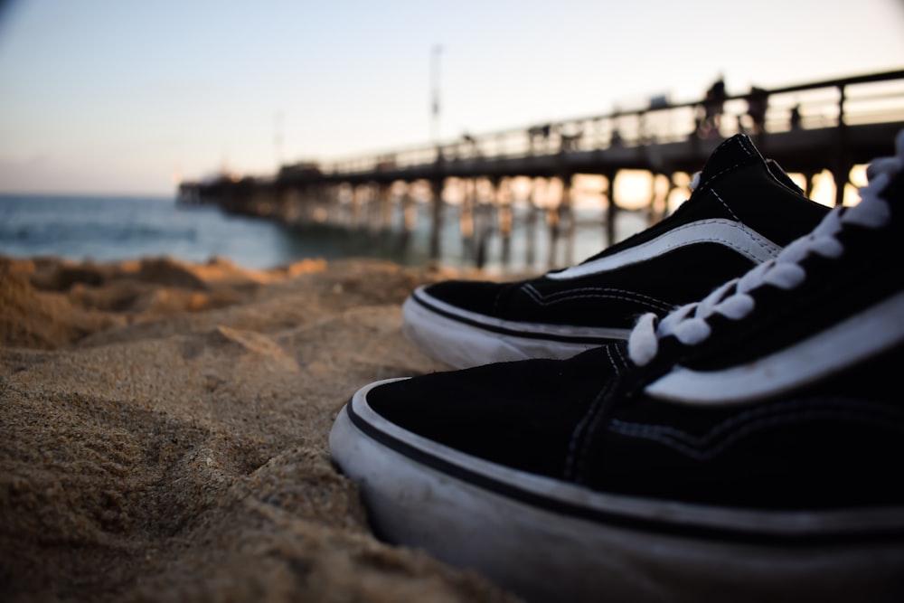 shallow focus photography pair of black Vans Old Skool sneakers