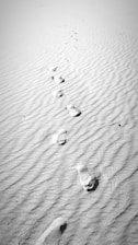 Close-up of footprints on a dusty path symbolizing a personal journey.