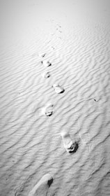 Close-up of footprints on a dusty path symbolizing a personal journey.