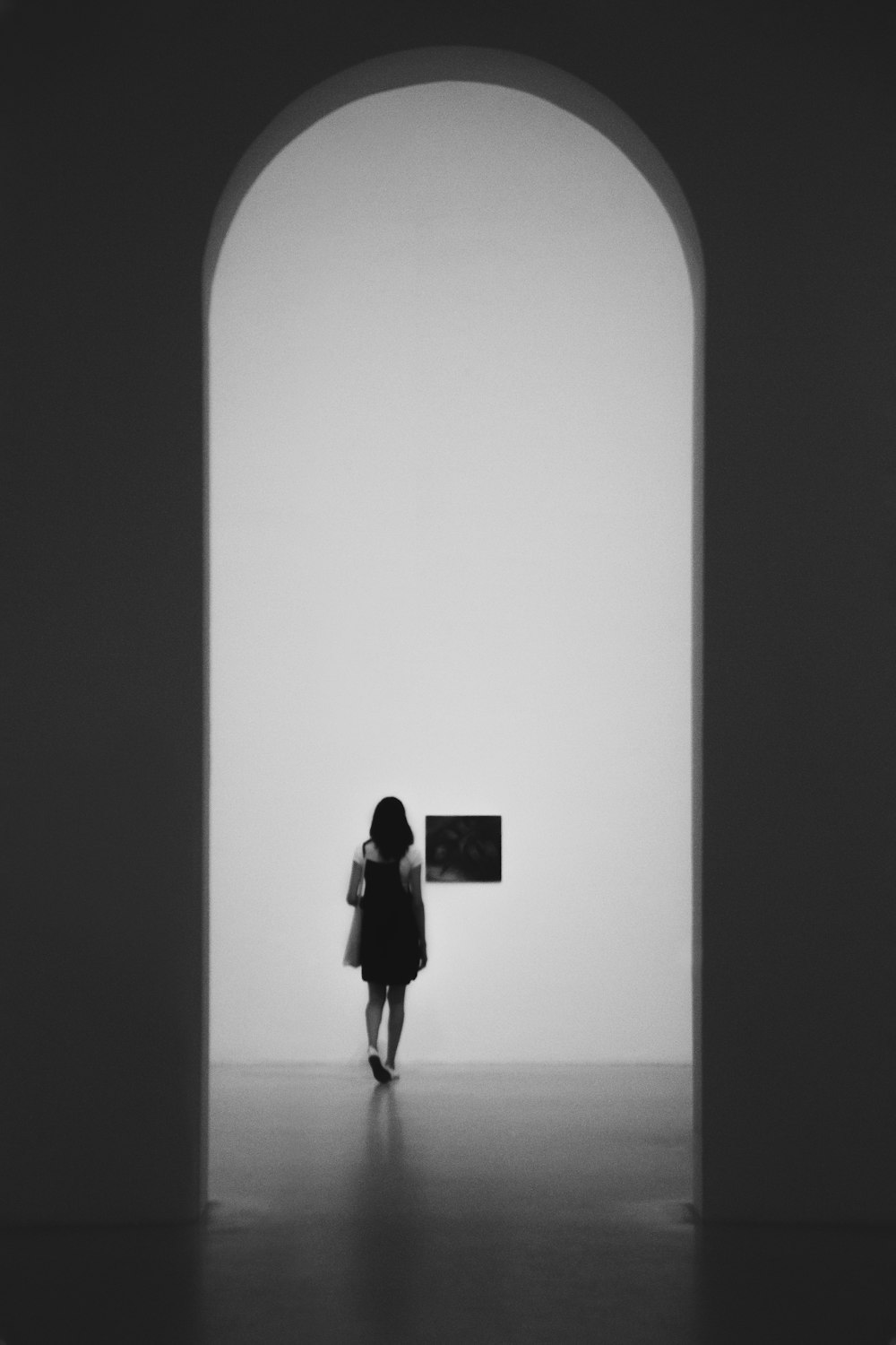 woman wearing black backpack standing inside building