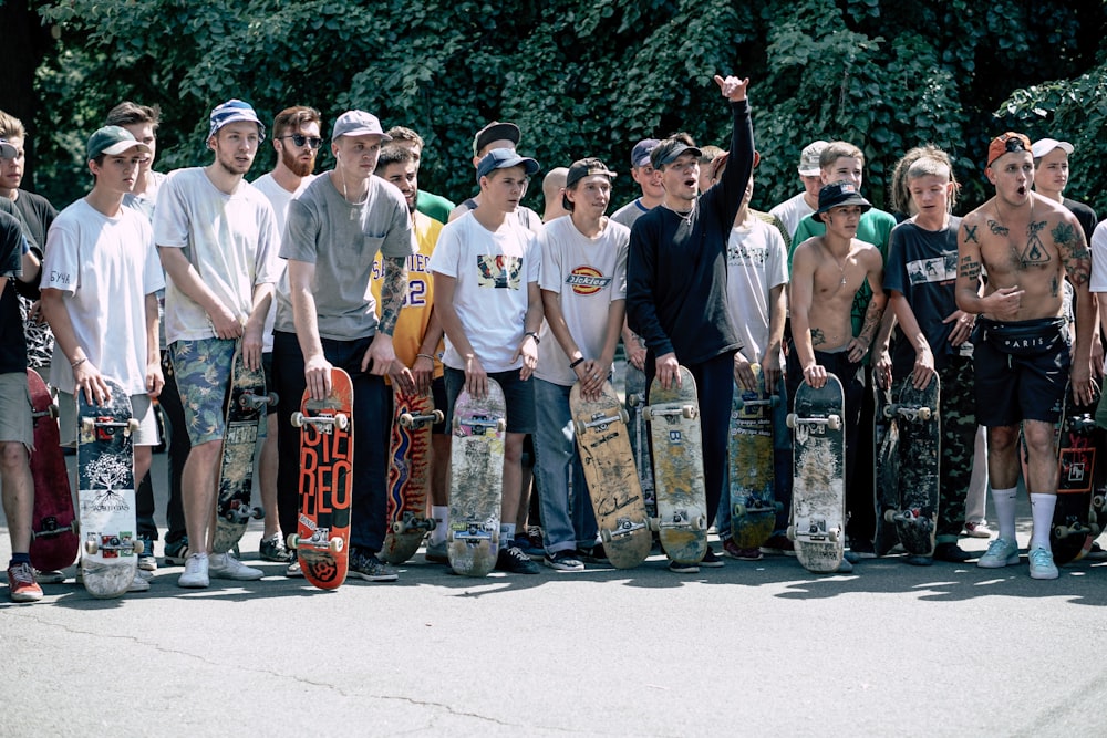 people holding skateboards