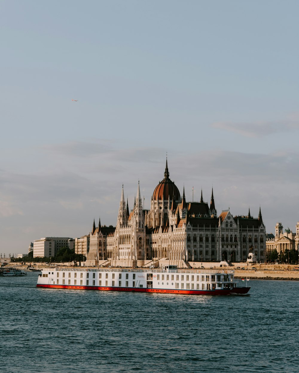 a large white and red boat in a body of water