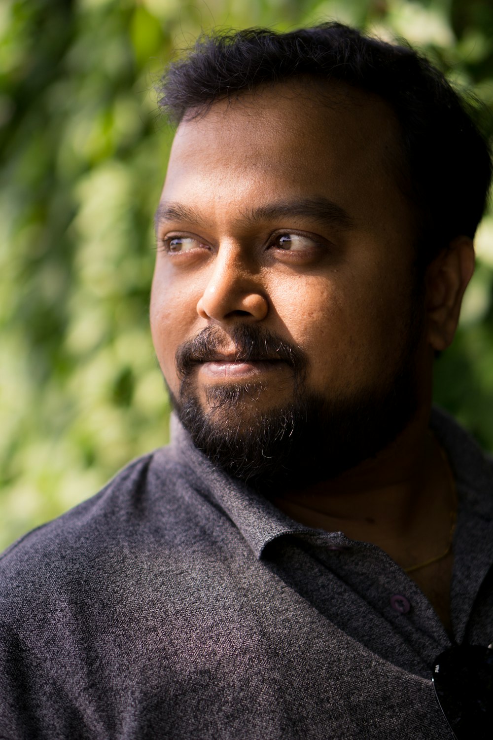 man wearing black polo shirt outdoor during daytime