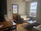 A bright and tidy living room with sunlight streaming in.