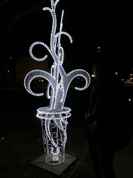 A glowing sculpture mid-transformation, blending metal and light.