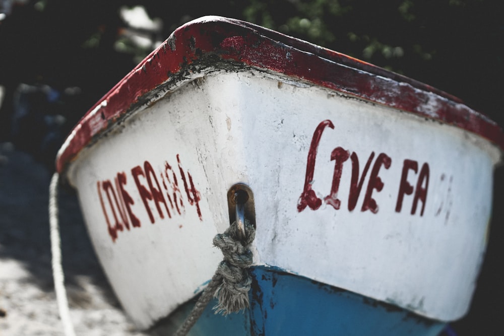 selective focus photography of white and red wooden boat