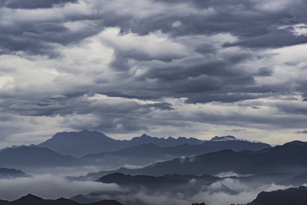 panoramic photography of mountain with fogs