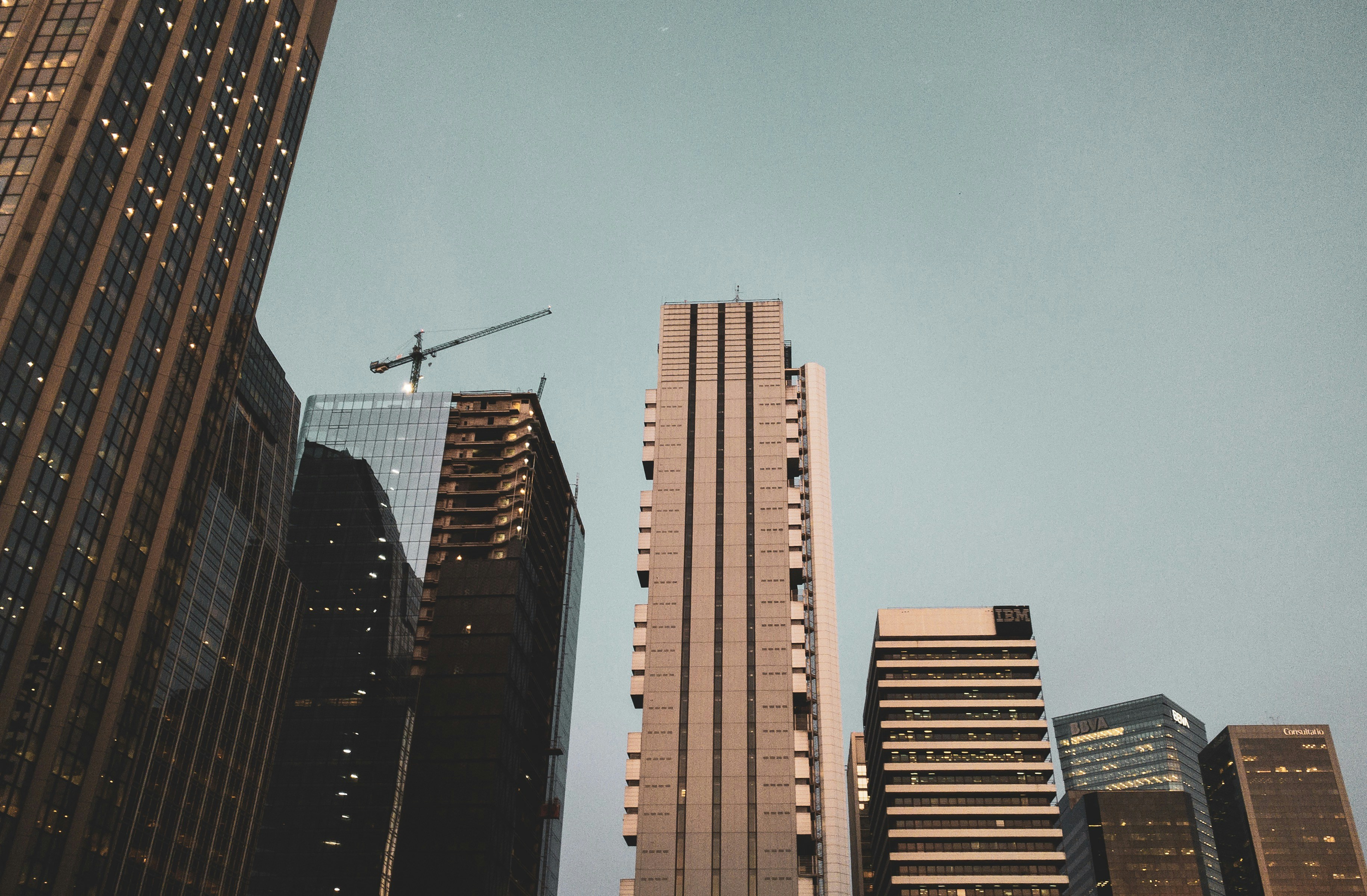 low-angle photography of high-rise buildings under calm blue sky