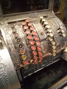 Photo of a vintage cash register with old banknotes and coins.