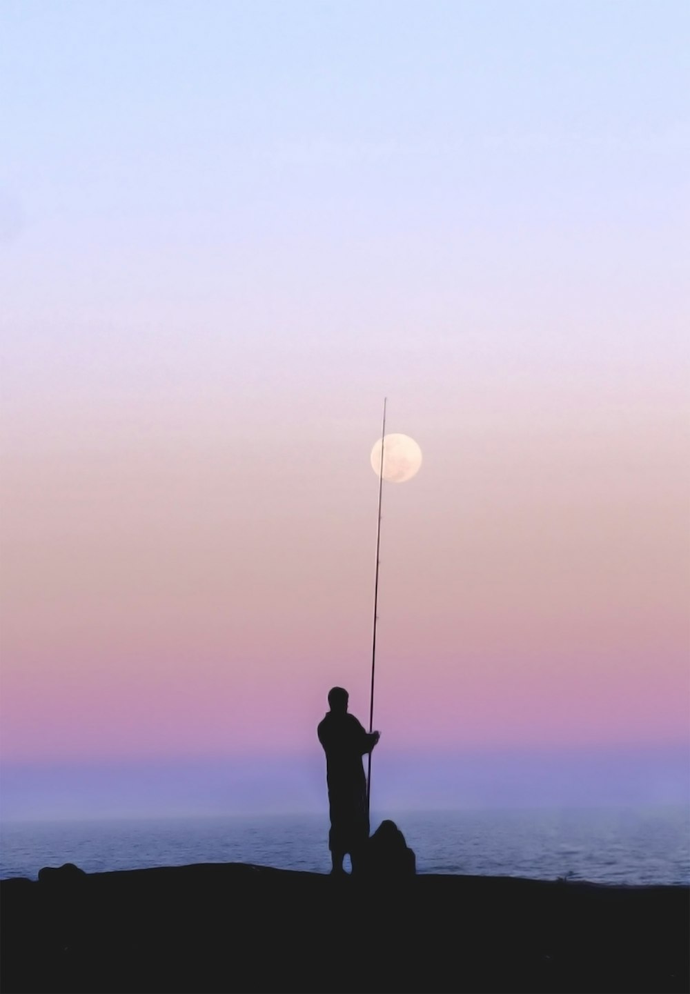 silhouette of man near sea