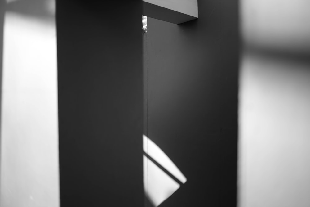 a black and white photo of a mirror and a light fixture