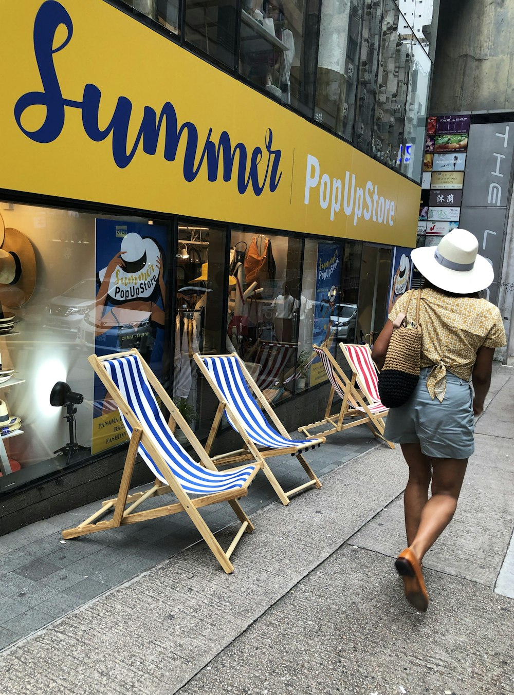 woman walking beside folding chairs