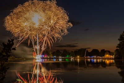 Fireworks reflecting beautifully over a calm lake during a special celebration.