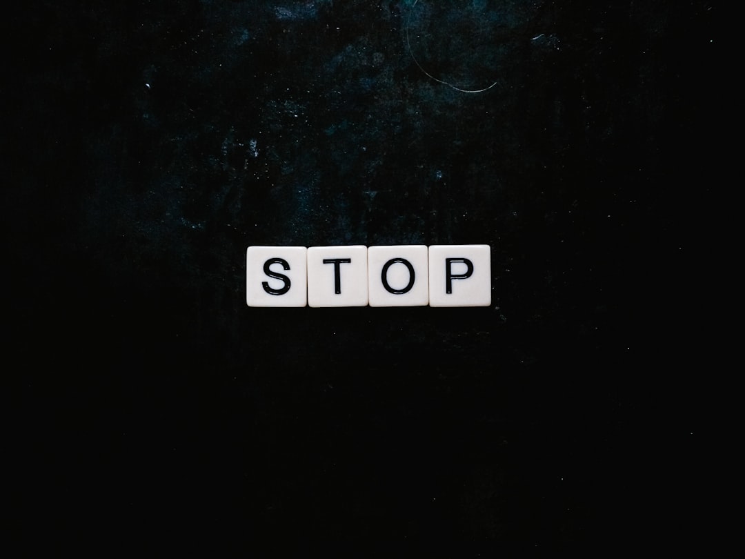stop text with black background, Stop spelt out using Scrabble letters flatlay