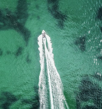 A scenic speedboat cruising over sparkling ocean waves.