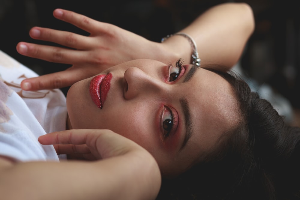 women holding her face close-up photography